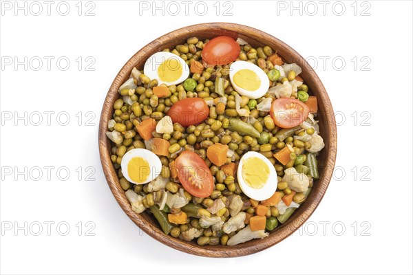 Mung bean porridge with quail eggs, tomatoes and vegetables isolated on white background. Top view,