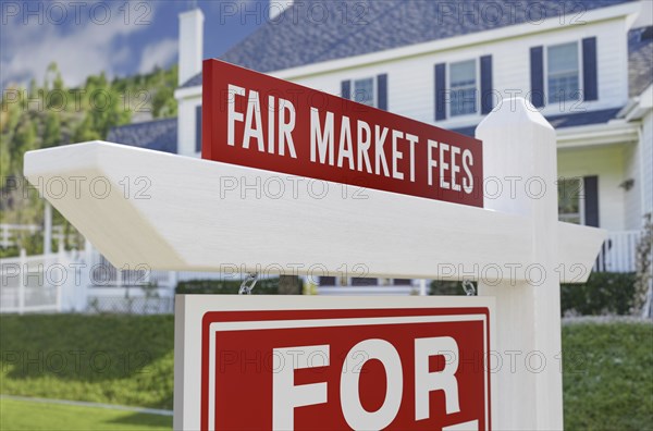 Fair market fees for sale real estate sign in front of new house