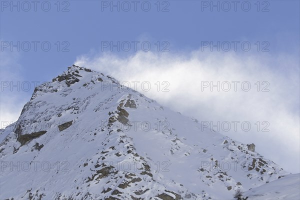 Snow covered mountain top, pinnacle Cima dell'Arolley in winter in the Gran Paradiso Massif of the