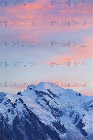 Red-coloured clouds over the summit of Mont Blanc with Aiguille du Midi in the foreground, Savoie,