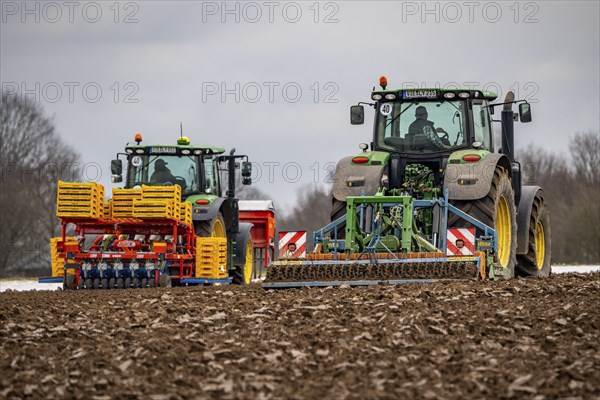 Tractor with a power harrow prepares the soil of a field for planting, Agriculture, Spring