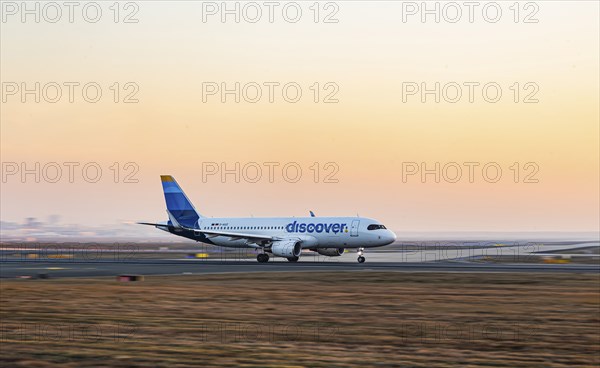 Discovery Airlines aircraft taking off in the early morning, new design, aircraft registration: