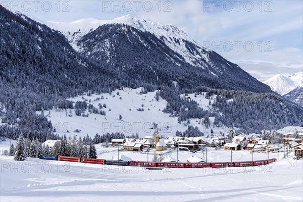 Rhaetian Railway train on the Albula railway Passenger train in the Alps in Bergün, Switzerland,