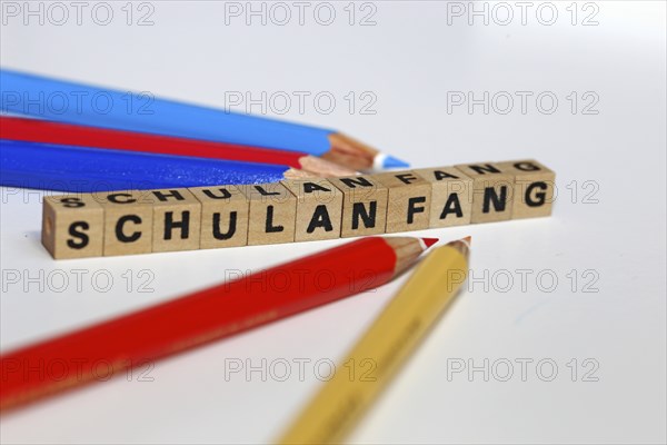 Symbolic image for the start of the new school year with letter cubes and pens