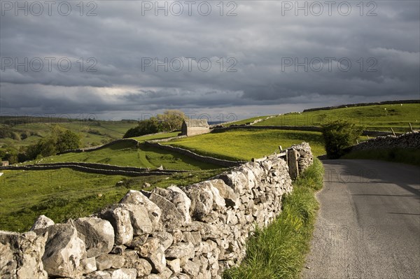 Old barn and dry stonewalls, Malham, Yorkshire Dales national park, England, UK