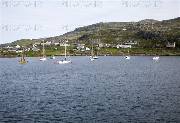 Yachts moored in the harbour at Castlebay, Barra, Outer Hebrides, Scotland, UK