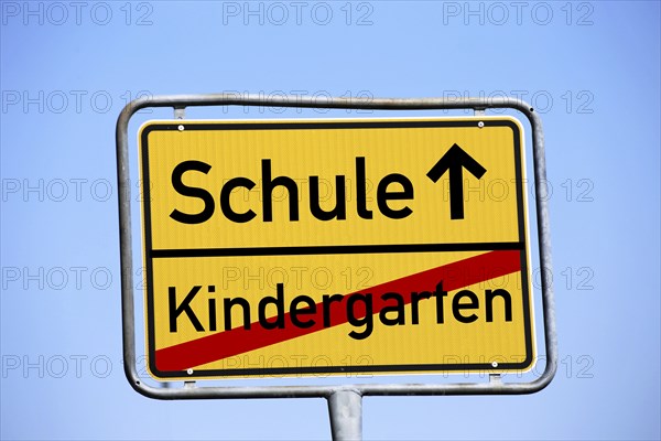 Start of school symbol: Town exit sign with the lettering Kindergarten / School