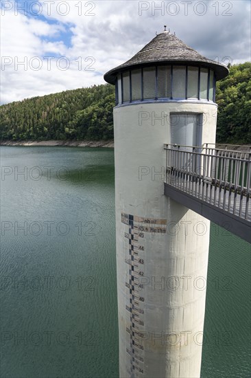 The dam wall of the Urft dam, Grundablassturm, merges into the Rursee, Eifel National Park, North