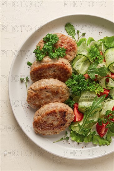 Fried cutlets, turkey, with vegetable salad, top view, no people