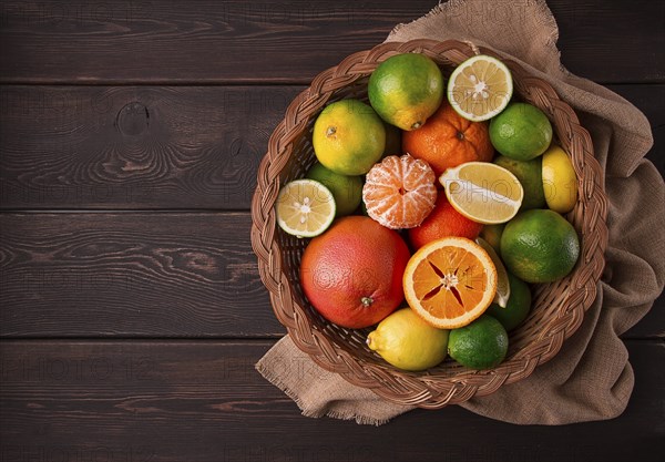 Assortment, citrus fruits, in a basket, close-up, top view, no people