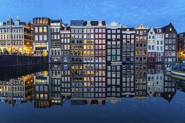 Canal houses on the Damrak, in the centre of the old town of Amsterdam, harbour, starting point of