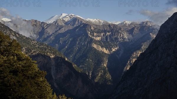 High, rocky mountains with snow-covered peaks under a clear sky, Lefka Ori, Omalos Plateau,