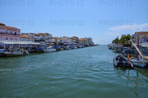 Coastal town with colourful houses, boats in the water, on a sunny day, summer, Le Grau-du-Roi,