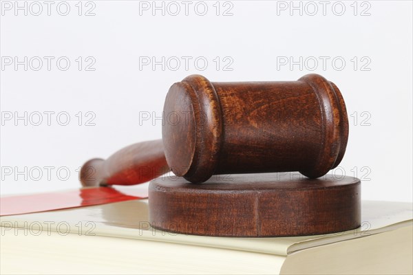 Book and judge's gavel as a symbolic image for a court judgement