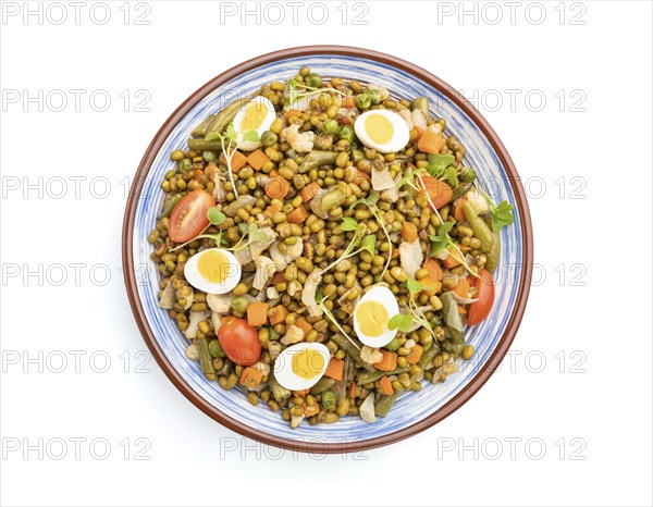 Mung bean porridge with quail eggs, tomatoes and microgreen sprouts isolated on a white background.