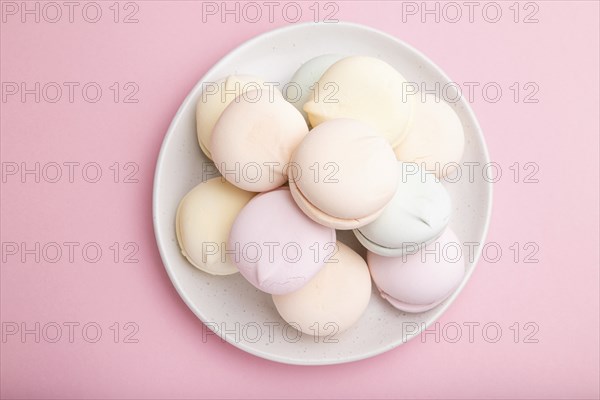 Colored zephyr or marshmallow on pastel pink background. Top view, close up