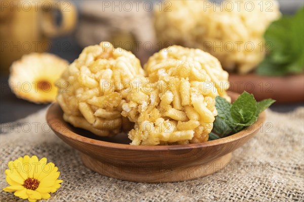 Traditional Tatar candy chak-chak made of dough and honey with cup of coffee on a black concrete