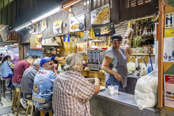 Visitors sitting at a food stall at the counter, Mercado Central de San José, San José, Costa Rica,