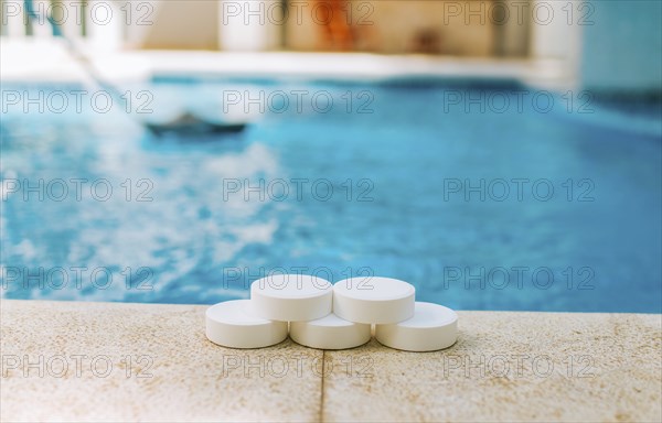 Chlorine tablets for swimming pool cleaning. close up of chlorine tablets on the edge of a swimming