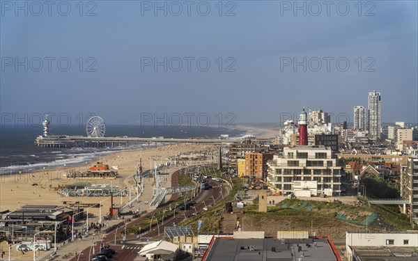 View over the beach of Scheveningen, the pier with Ferris wheel and the skyline of the town, which