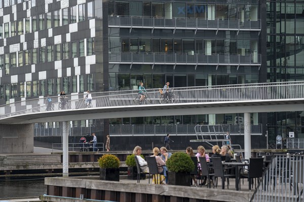 Cyclists on the Cykelslangen cycle and pedestrian bridge, at the Fisketorvet shopping centre,