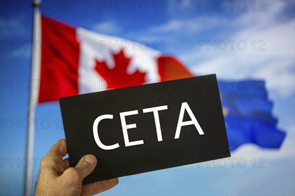 Sign reading CETA in front of the flags of Canada and the European Union. The abbreviation CETA