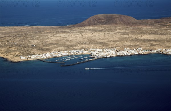 Ferry ship approaching Caleta del Sebo, La Graciosa island, Lanzarote, Canary Islands, Spain view