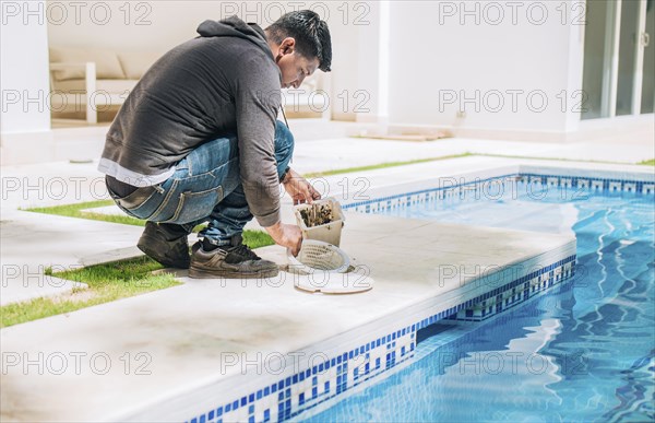 Man cleaning swimming pool filter basket. Person cleaning garbage filter basket for swimming pool