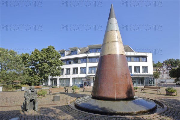 Pointed round pyramid and sculpture with monument to the town's history of the mineral water