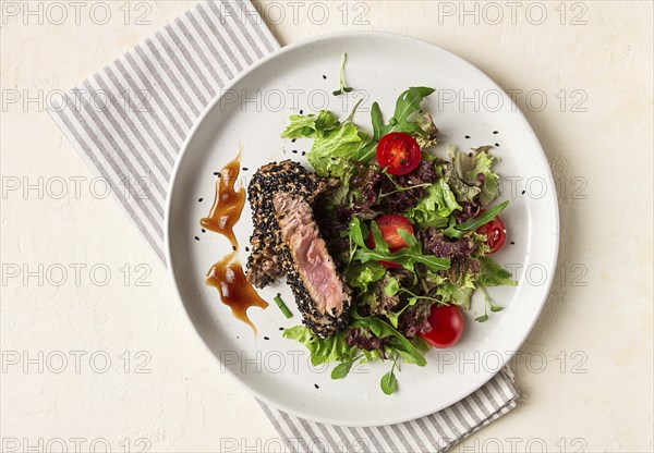 Vegetable salad, with fried tuna, in sesame seeds, healthy food, top view