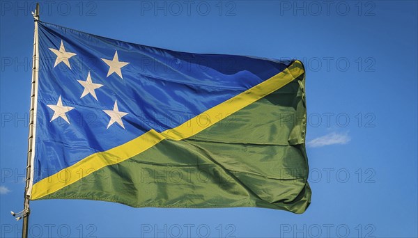 The flag of Solomon Islands, Solomon Islands, island nation in the South Seas, flutters in the