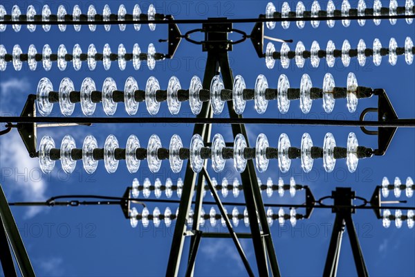 Insulators made of glass on a high-voltage line, they hang on the pylons as a suspension device