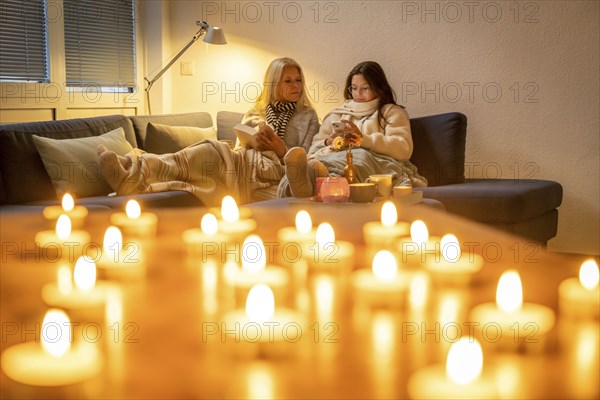Symbolic image energy saving, cold winter, energy crisis, cold flat, mother and daughter lying on