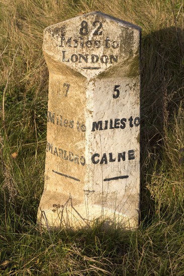 Old milestone road marker on A4 road Beckhampton, Wiltshire, England, UK