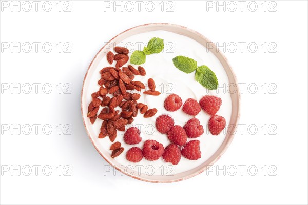 Yogurt with raspberry and goji berries in ceramic bowl isolated on white background. top view, flat