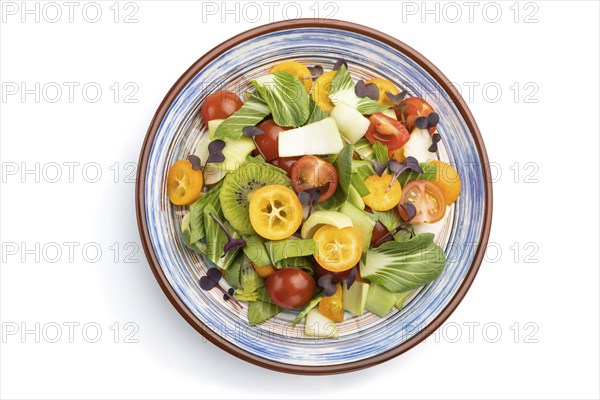 Vegetarian salad of pac choi cabbage, kiwi, tomatoes, kumquat, microgreen sprouts isolated on white