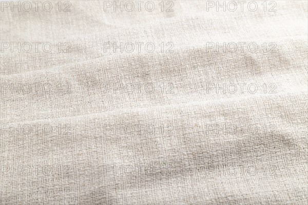 Fragment of white linen tissue. Side view, natural textile background and texture. wave concept,