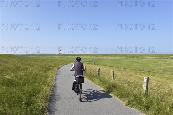 Cycling at the Westerheversand lighthouse, Schleswig-Holstein, Germany, Europe