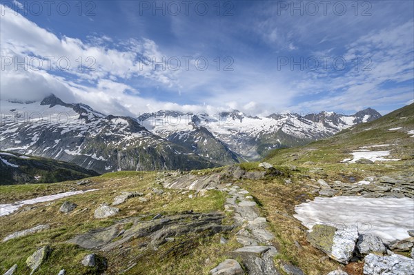 Hiking trail in a picturesque mountain landscape, mountain peaks with snow and glacier