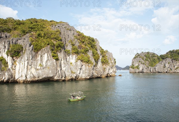 Fishing boat and the karst rocks in Lan Ha Bay, Halong Bay, Vietnam, Asia