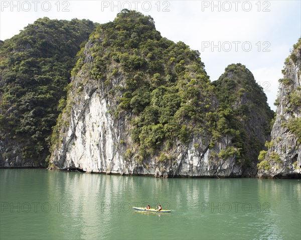 Yellow kayak and the karst rocks in Lan Ha Bay, Halong Bay, Vietnam, Asia