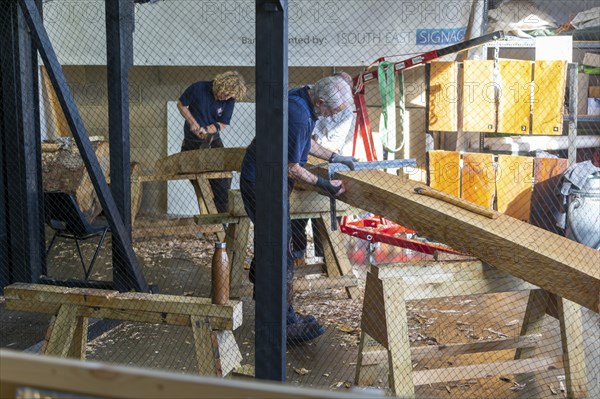 Craftsmen working on reconstruction of Anglo-Saxon ship from Sutton Hoo, Longshed building,