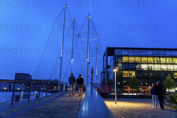 Cyclists on the Cirkelbroen cycle and pedestrian bridge, over the harbour, in the Christianshavens