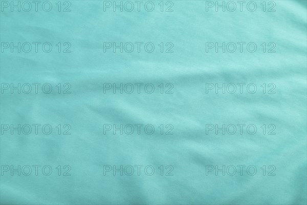Fragment of smooth silk blue tissue. Top view, flat lay, natural textile background and texture