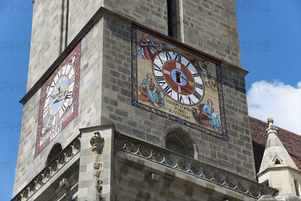Close-up of a church tower with a large clock and colourful frescoes, Black Church, Old Town,