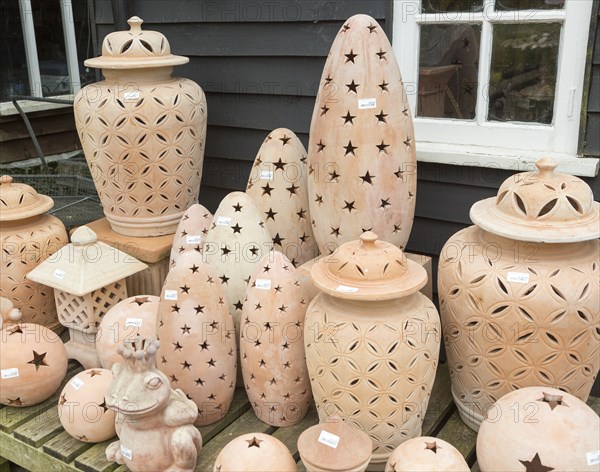 Display of clay lanterns on sale, The Walled garden plant nursery, Benhall, Suffolk, England, UK