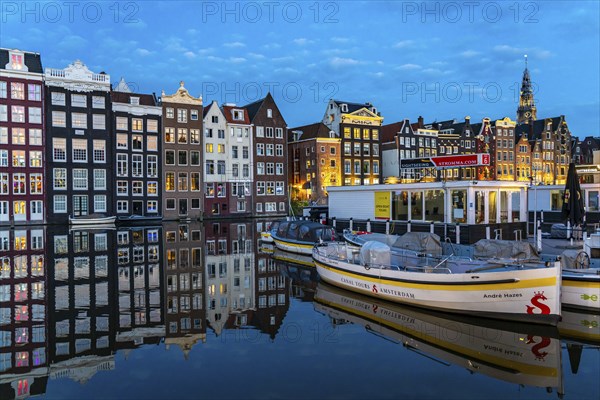 Canal houses on the Damrak, in the centre of the old town of Amsterdam, harbour, starting point of