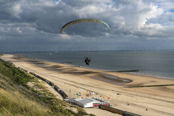 Paragliders along the dunes of Zoutelande, in Zeeland, South Holland, Netherlands