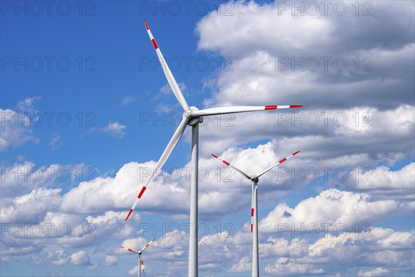 Wind turbine, wind energy plant from the manufacturer Enercon, blue sky with many white clouds,