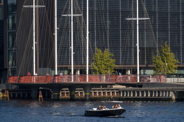 Cyclists on the Cirkelbroen cycle and pedestrian bridge, over the harbour, in the Christianshavens